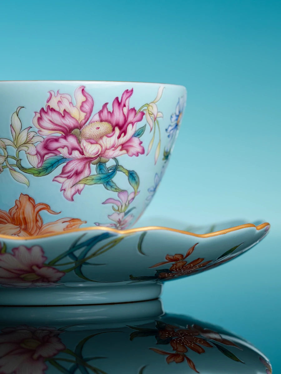 Floral porcelain cup and saucer against a blue background
