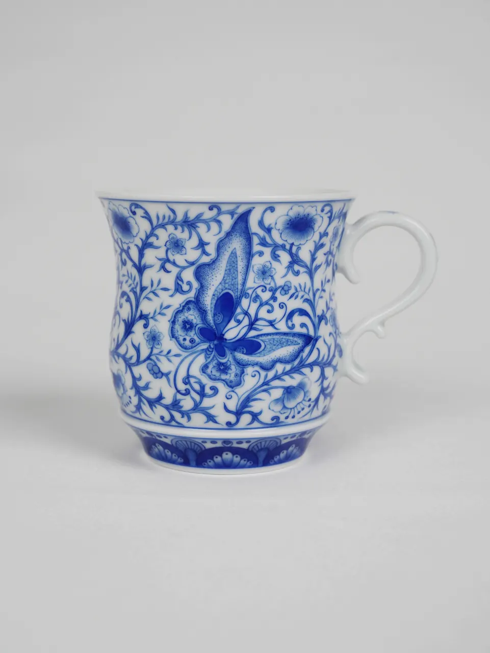 Front view of the blue butterfly porcelain cup and saucer