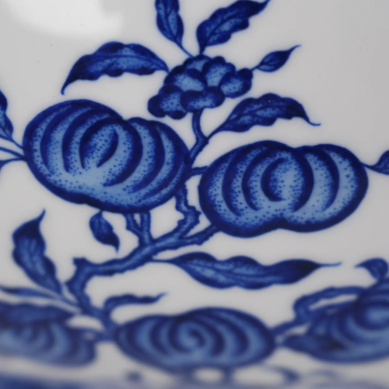 Close view of the fruit motif on the vase body