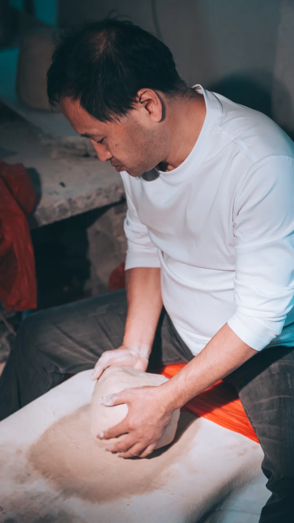 A porcelain artisan shaping clay by hand