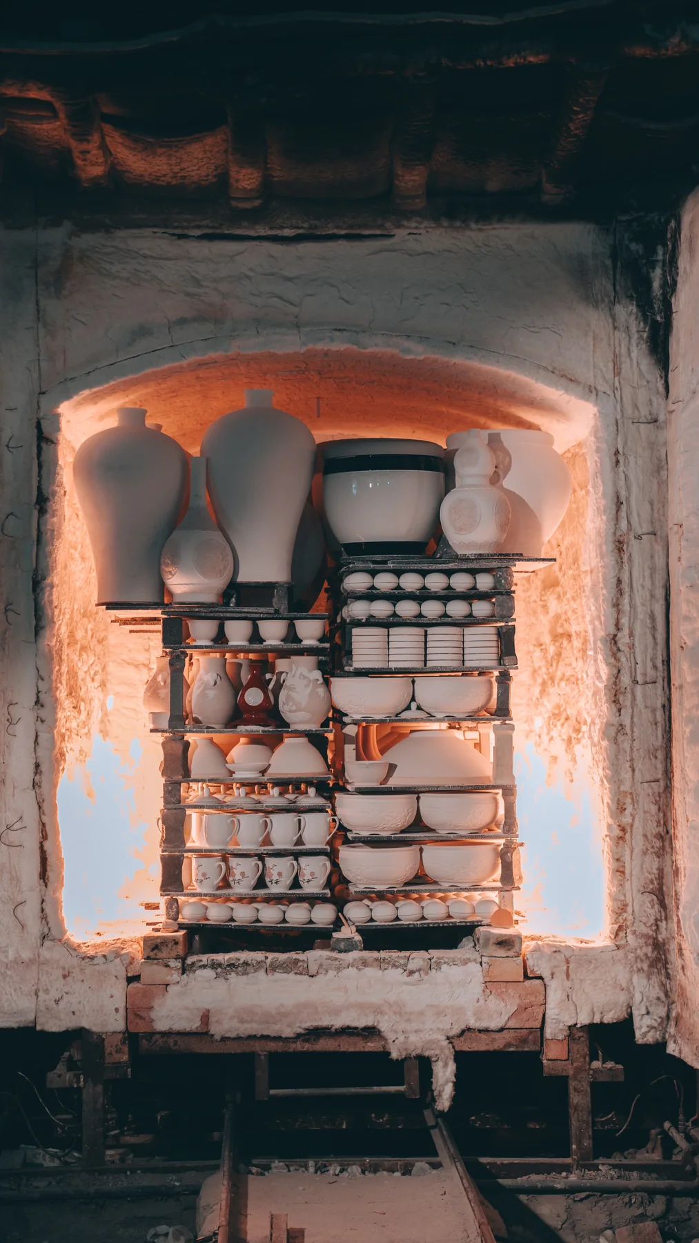 Porcelain vessels inside a glowing kiln