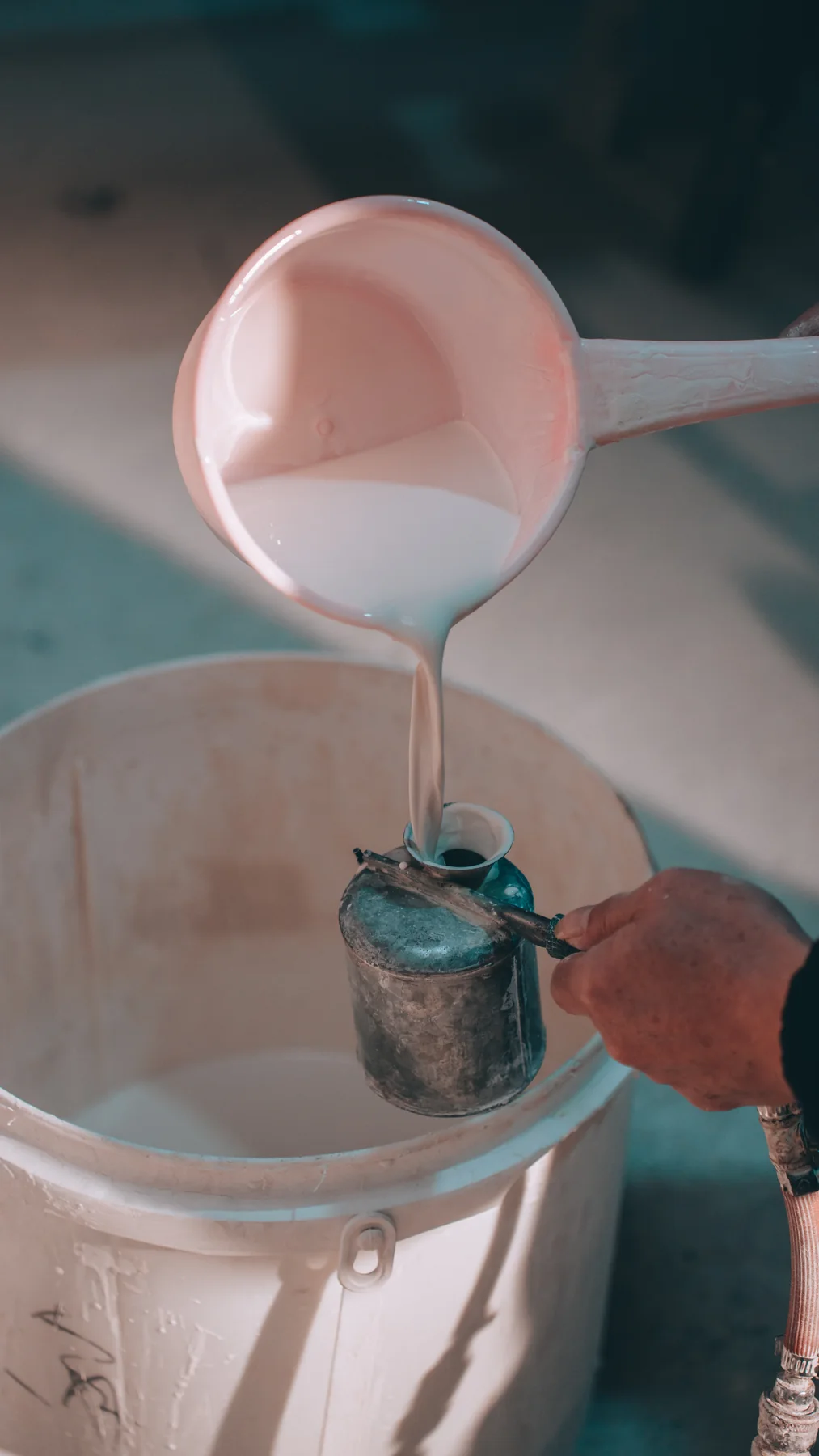 Porcelain slip being poured into a working vessel