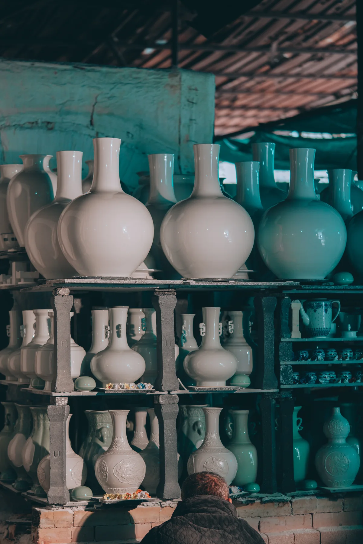 Porcelain vessels arranged in a Jingdezhen workshop
