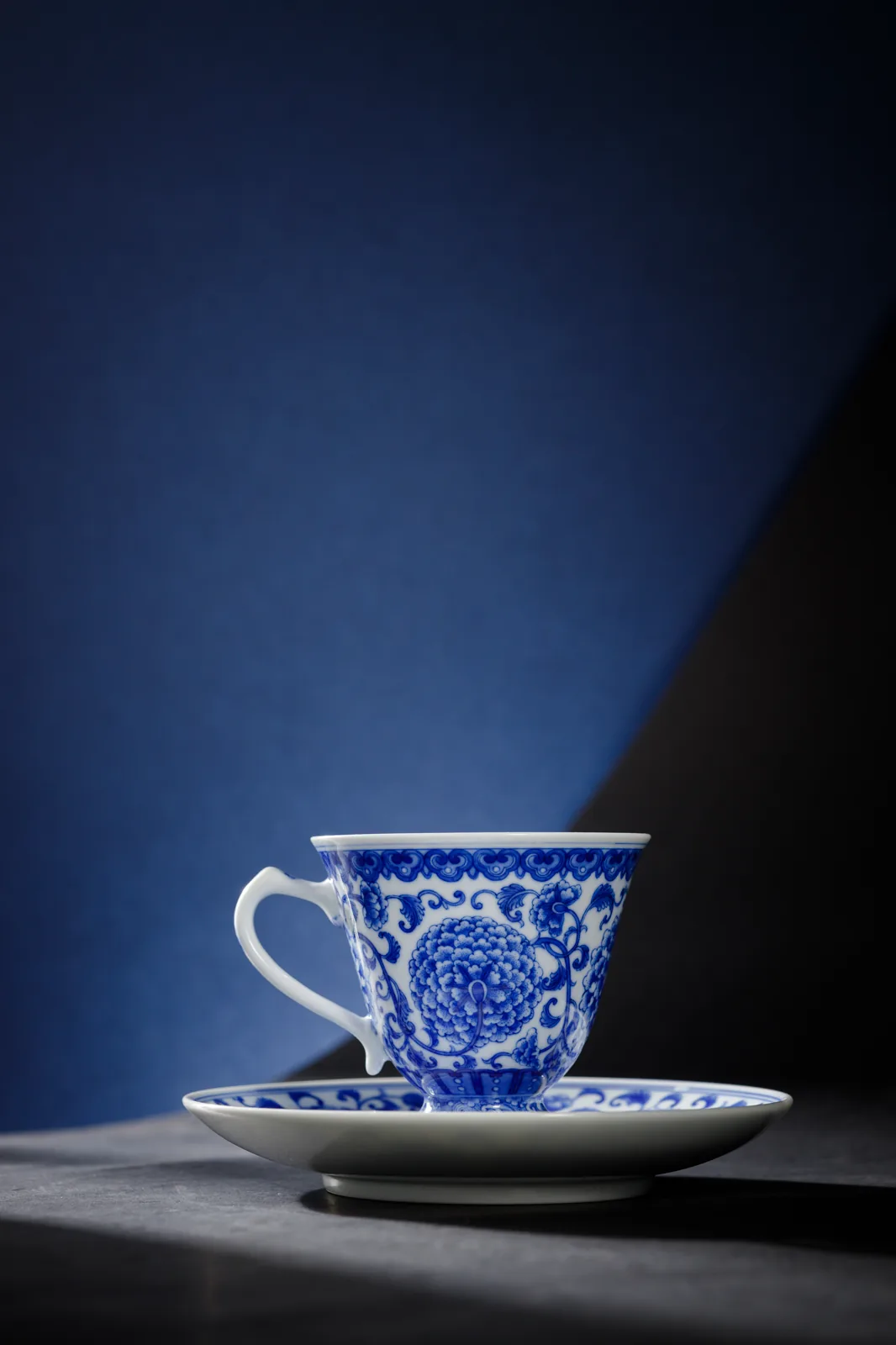 Peony Scroll Cup and saucer in a blue-toned setting